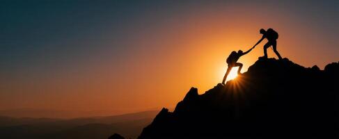 The climbers assist each other to reach the summit at sunset. photo