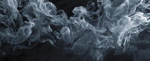 The ethereal swirls of smoke dancing in a mysterious dark background. photo