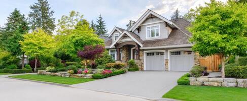 The charming suburban house surrounded by beautiful landscaping and lush greenery. photo