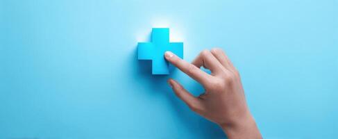 The hand interacting with a blue medical plus symbol on a vibrant background. photo