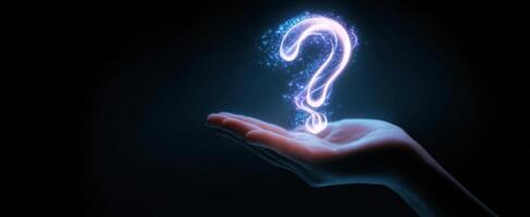 The Hand Holding a Glowing Question Mark in a Dark Environment photo