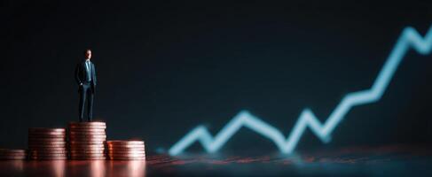 The businessman standing on coins with an upward growth graph background. photo
