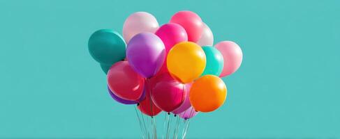 The vibrant balloons floating joyfully against a bright turquoise background photo