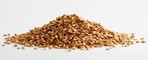 The pile of natural sesame seeds on a white background. photo