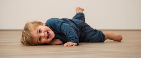 The joyful child playing on the floor with a bright smile. photo