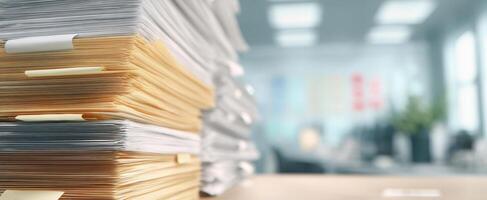 The stacked files and folders in a modern office setting. photo
