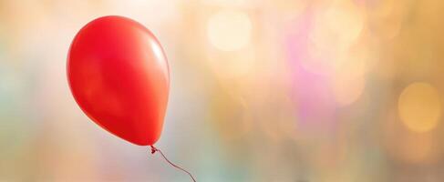 The vibrant red balloon floating against a dreamy bokeh background. photo