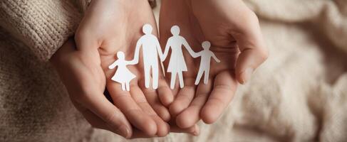 The Family Connection Symbolized by Paper Figures in Hands photo