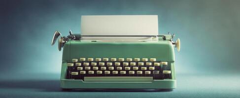 The vintage typewriter on a turquoise background with blank paper ready for use. photo