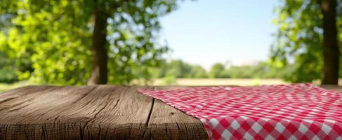 The inviting picnic table adorned with a red checkered cloth in nature. photo