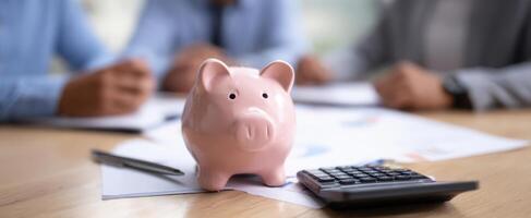 The piggy bank as a symbol of savings in a business financial meeting. photo