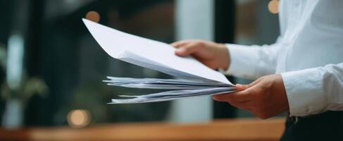 The hands holding important papers in a modern office environment photo
