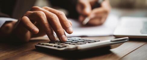 The calculator and hands engaged in business calculations and financial analysis. photo