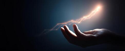 The hand releasing a spark of energy into the darkness. photo