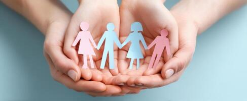 The Hands Supporting Colorful Paper Figures Representing Family and Unity photo