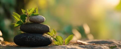 The serene stacked stones surrounded by fresh green leaves in nature. photo