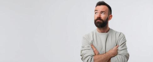 The thoughtful man with arms crossed contemplating life's deeper questions. photo