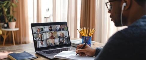 The individual engaging in a virtual meeting from a home workspace. photo