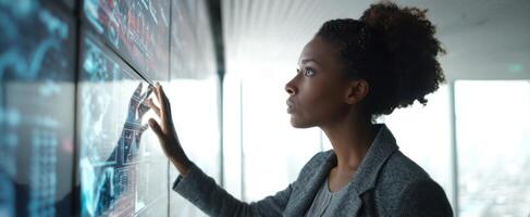 The woman interacting with advanced digital technology in a modern office setting. photo