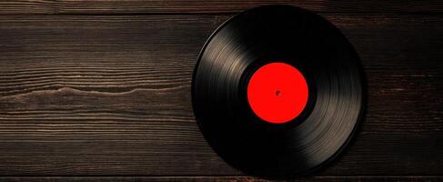 The vibrant vinyl record resting on a rustic wooden background photo