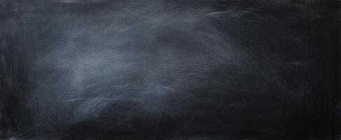 The textured black background featuring a smooth chalkboard surface for creative use. photo