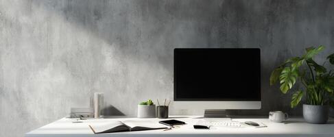 The modern desk setup with computer, plant, and stationery elements. photo