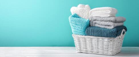 The cozy arrangement of soft towels in a woven storage basket. photo