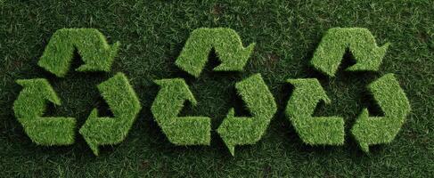 The green recycling symbol made of grass on a natural background. photo