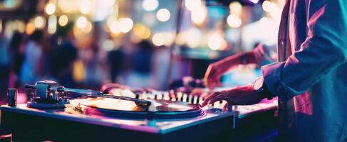 The DJ creating an electrifying atmosphere with vibrant tunes and lights. photo