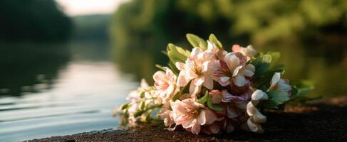 The delicate bouquet of flowers resting gently beside a tranquil river. photo
