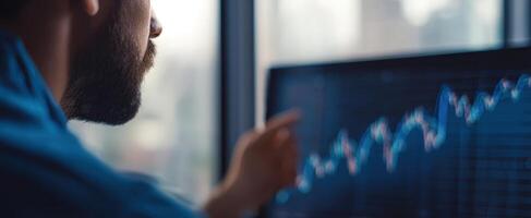 The man analyzing stock market trends and data on a computer screen. photo