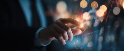 The hand interacting with a digital financial data interface and graphs. photo