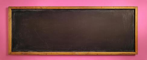 The empty chalkboard framed against a vibrant pink wall photo