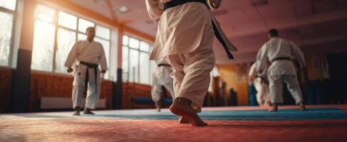 The dynamic footwork of karate practitioners training in a dojo setting. photo