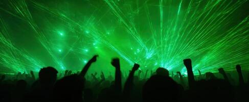The vibrant crowd enjoying an electrifying laser show at a concert. photo