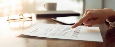 The document being reviewed by a focused professional in a modern workspace. photo