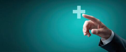 The hand pointing towards a positive cross symbol on a blue background. photo