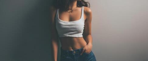The confident woman posing in stylish casual wear against a neutral backdrop. photo