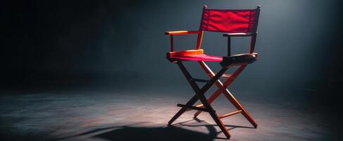 The iconic red director's chair in a dramatic illuminated setting photo
