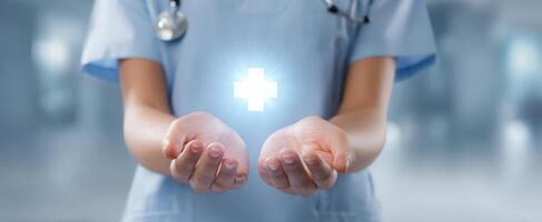 The nurse's hands offering a glowing health symbol in a hospital setting. photo