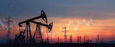 The oil pumpjack silhouette against a vibrant sunset with financial data overlays. photo