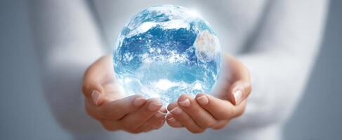 The hands holding a glowing Earth symbolizing hope and unity for the future. photo