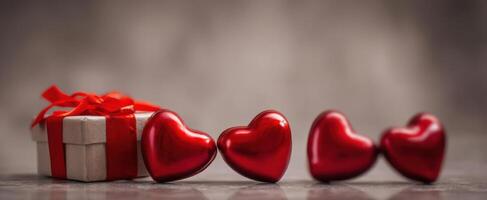 The vibrant red hearts and gift box ideal for romantic celebrations. photo