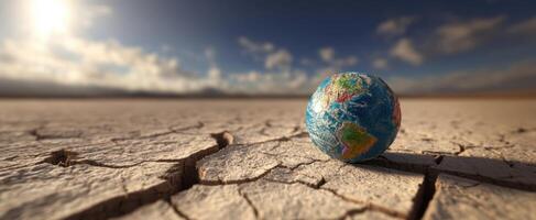 The Earth resting on dry cracked soil under a dramatic sky photo