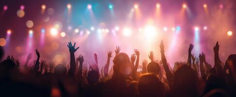 The vibrant crowd celebrating at an electrifying concert under dazzling lights. photo