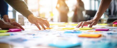 The collaboration of hands working on creative ideas with sticky notes. photo