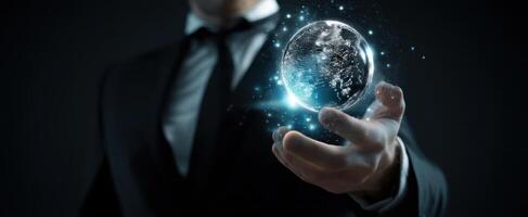 The businessman holding a glowing globe representing innovation and global connection. photo