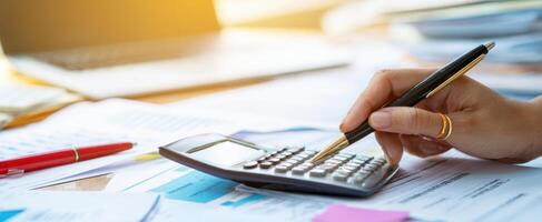 The calculator and pen poised for financial documentation and analysis. photo