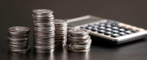 The stacks of coins alongside a calculator for financial planning and budgeting. photo