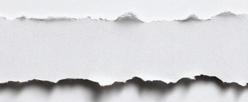 The torn edges of white paper revealing an elegant minimalist background. photo